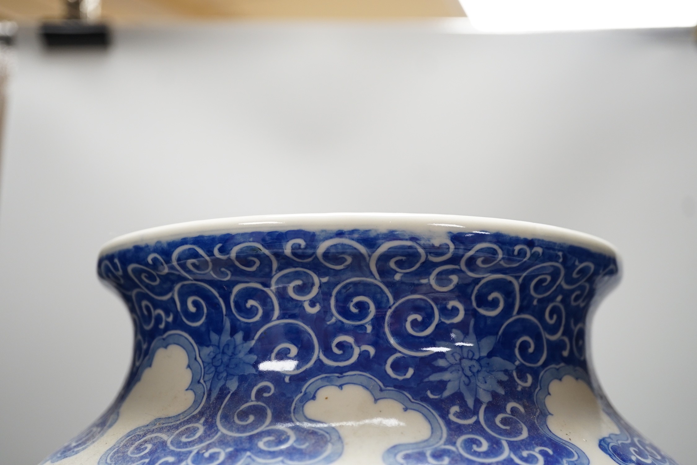 A large Japanese blue and white vase decorated with foliage and birds, 49cms high